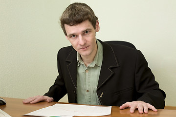 Image showing Clerk at office sits at a desktop