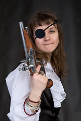 Image showing Girl - pirate with pistol in hand and eye patch