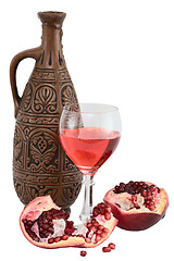 Image showing Glass of wine, bottle and a red pomegranate