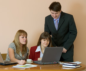Image showing Girls at a desktop and their chief