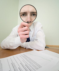 Image showing Guy looks through the magnifier