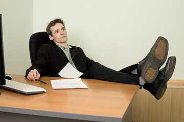 Image showing Boss in black suit on a workplace