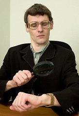 Image showing Person view a watch through a magnifier