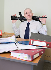 Image showing Self-satisfied worker of office armed with a rifle