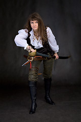 Image showing The girl - pirate with a sabre in hands