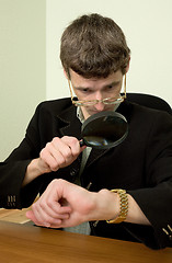 Image showing Person view a watch through a magnifier