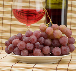 Image showing Glass bottle, goblet and grape