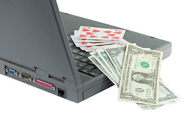 Image showing Laptop, playing cards and dollars