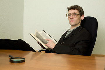 Image showing Guy in eyeglasses reads the book