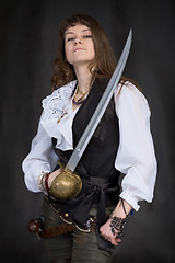 Image showing The girl - pirate with a sabre in hands