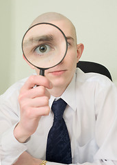 Image showing Guy looks through the big magnifier