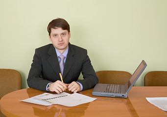 Image showing Businessman at a table with laptop