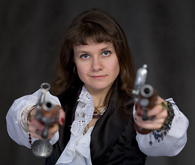 Image showing Girl - pirate with two ancient pistols in hands