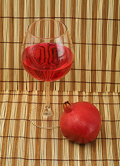 Image showing Glass of wine and red pomegranate
