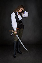 Image showing The girl - pirate with a sabre in hands