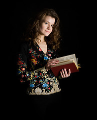 Image showing Girl with book on black background