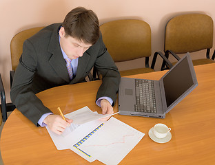 Image showing Businessman on a workplace with the laptop