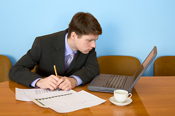 Image showing Businessman on a workplace with the laptop