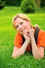 Image showing Young woman relaxing on the grass