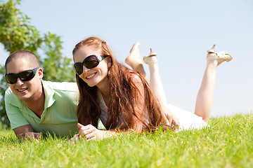 Image showing beautiful young Couple lie down on grass