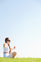 Image showing young women sitting and doing meditating