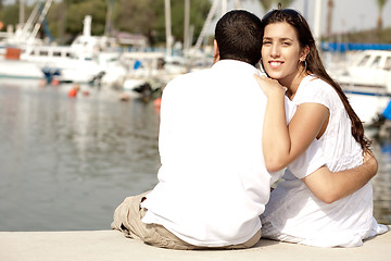 Image showing Young Couple Seated and Hugging On A Footbridge