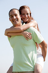 Image showing Young Man Piggybacking His Girlfriend