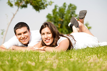 Image showing beautiful young Couple lie down on grass