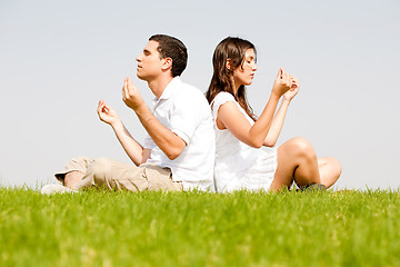 Image showing young couple doing meditating