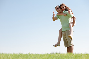 Image showing Man Piggybacking His Girlfriend