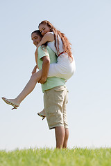 Image showing Young Man Piggybacking His Girlfriend