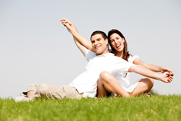 Image showing Young Couple Sitting Together Outside