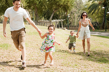 Image showing Family running with two young children