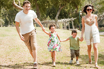Image showing Family running with two young children
