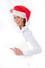Image showing Female Santa pointing down at blank billboard