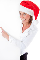 Image showing Female Santa pointing down at blank billboard