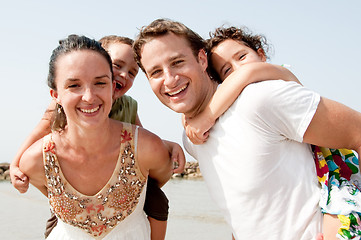 Image showing Couple With Children On Backs