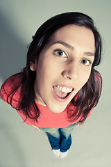 Image showing close-up of a cheerful young woman looking up top view