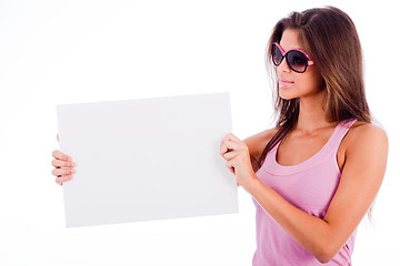 Image showing closeup of beautiful young women showing blank board stright half lenth