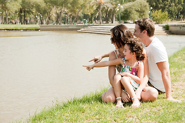 Image showing Family sitting near the lake