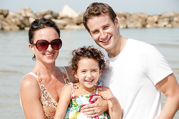 Image showing Family of three on the beach