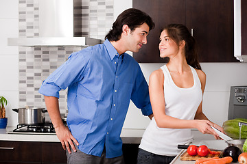 Image showing couple starring each other eyes in the kitchen