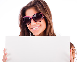 Image showing closeup of beautiful young women showing blank board and smiling