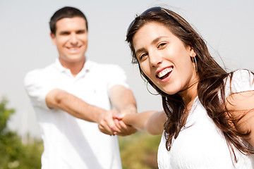 Image showing Happy young couple in playful mood focus on woman