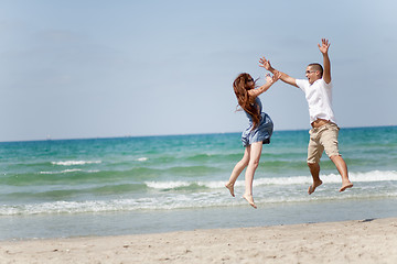 Image showing Happy young couple having fun on the beach