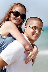 Image showing Smiling young couple piggybacking