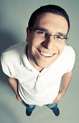 Image showing Isolated close-up of a cheerful young man looking up