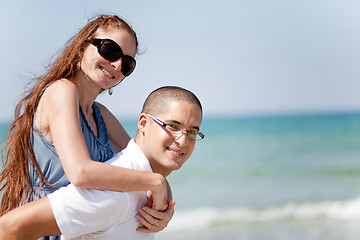 Image showing Young man piggyback his girlfriend