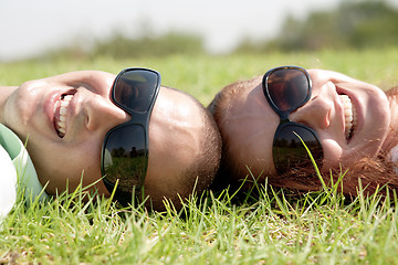 Image showing Happy young couple smiling on a lawn