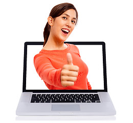 Image showing Young girl showing thumbs up getsure through laptop screen